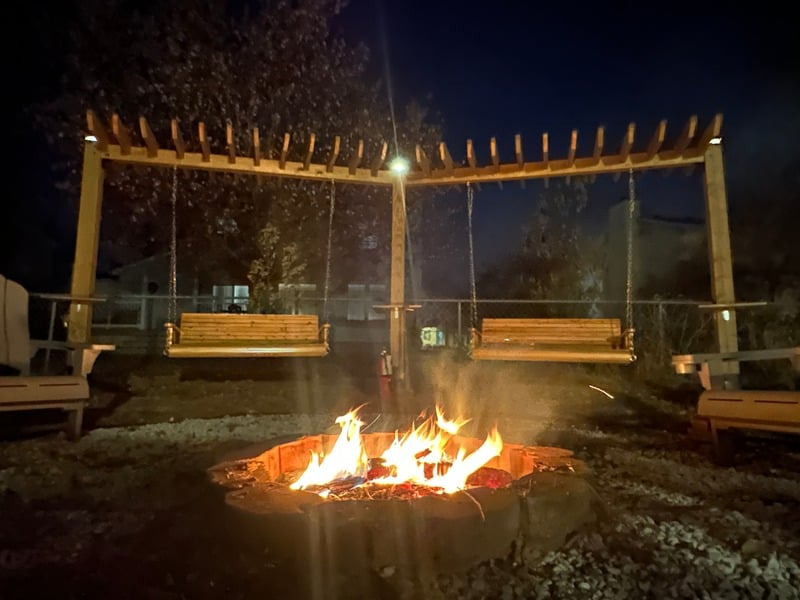 Custom outdoor swing set with fireplace feature